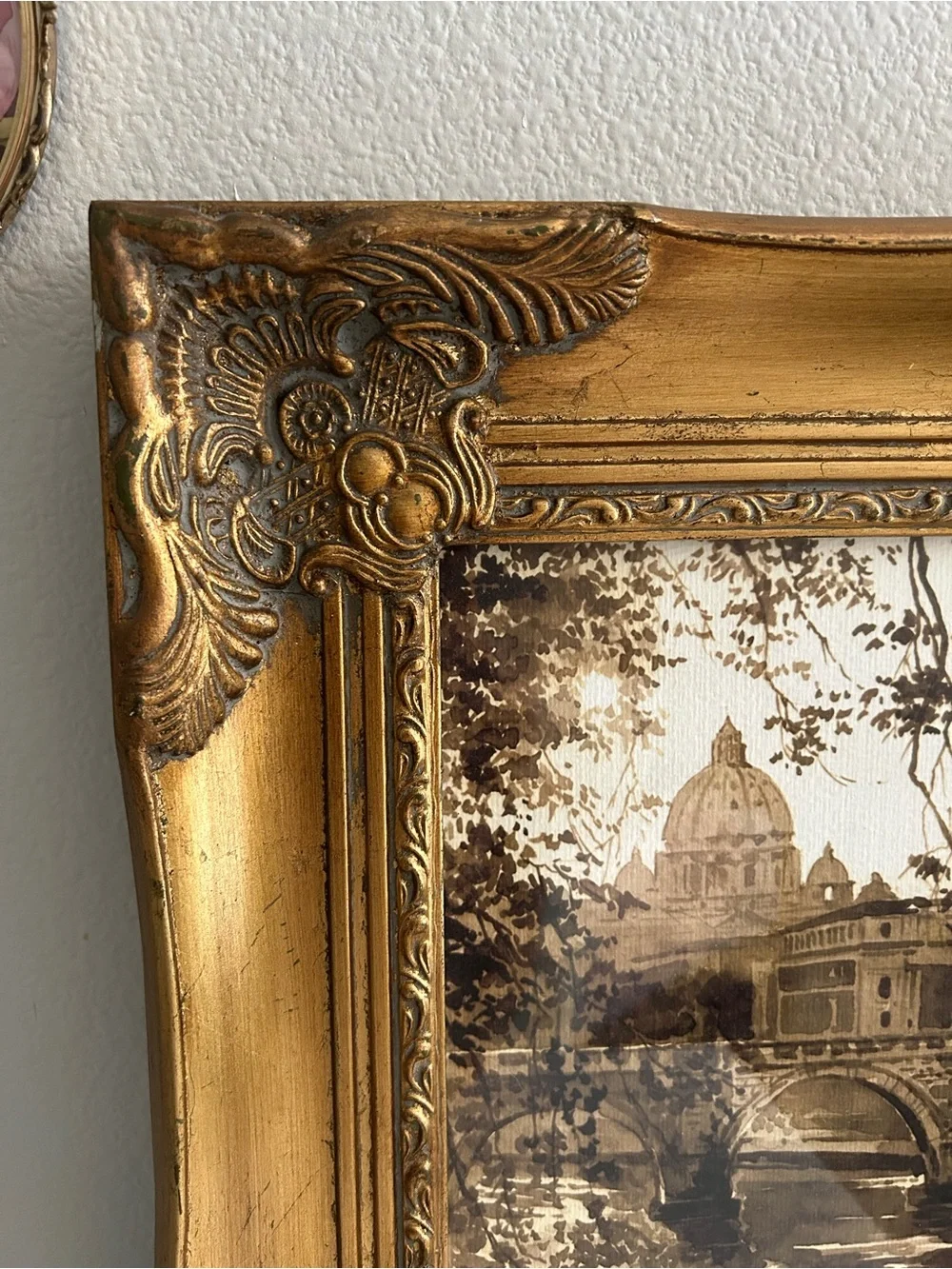 Framed art in gilded ornate frame